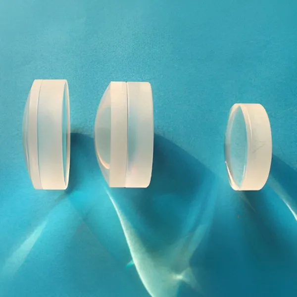 Three cylindrical achromatic lenses on a blue background
