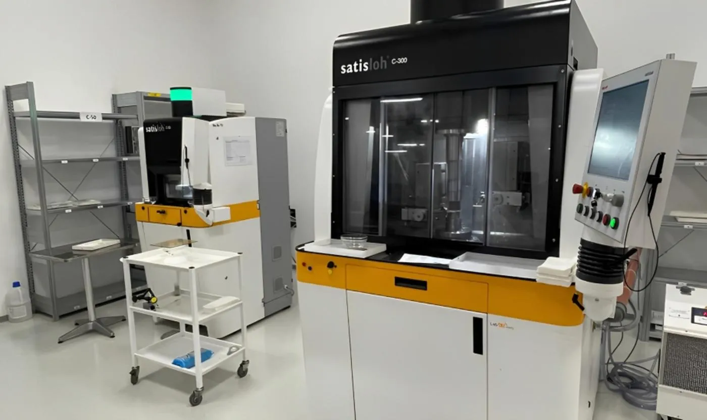 Satisloh optical processing machines in a clean, white workshop