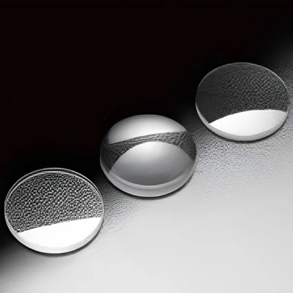 Three polished optical lenses on a dark background