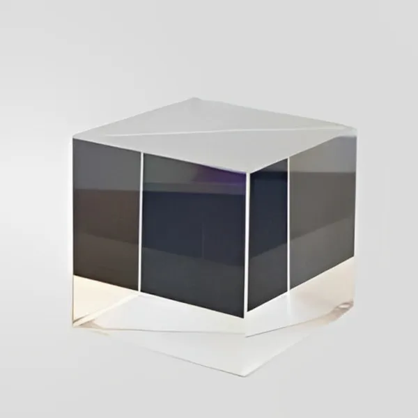 Metallic cube beam splitter on a light background