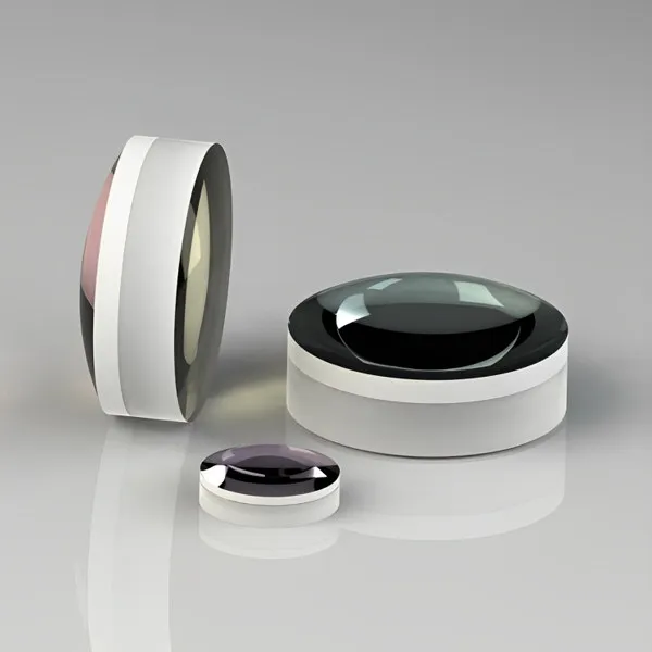 Three positive achromatic doublet lenses on a grey background