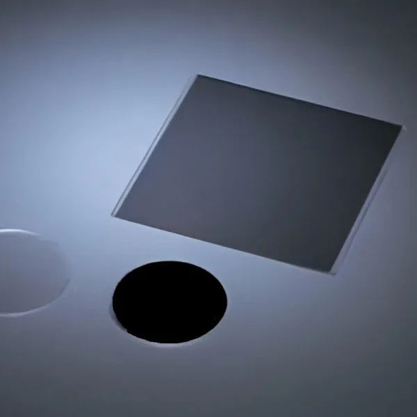 Square reflective neutral density filter on a blue-grey surface