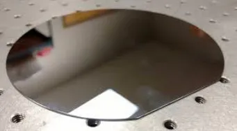 Polished circular wafer on an optical table